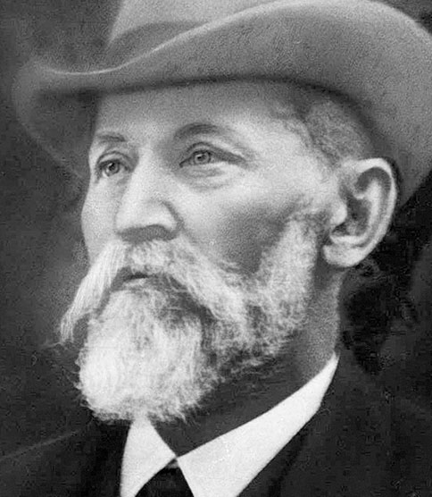 <h3>Création de la société LEDERLE</h3> Black and white portrait of an elderly bearded man wearing a wide-brimmed hat and formal attire.